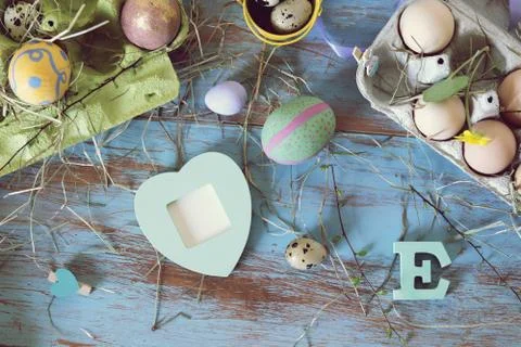 Eggs, quail, easter decor on a blue wooden table, top view Stock Photos