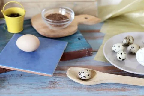 Eggs, quail, easter decor on a blue wooden table, top view Stock Photos