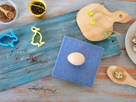 Eggs, quail, easter decor on a blue wooden table, top view Stock Photos