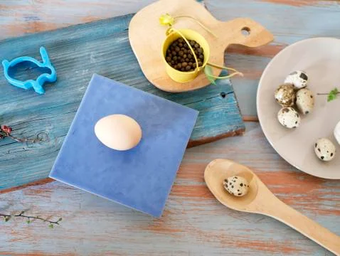 Eggs, quail, easter decor on a blue wooden table, top view Stock Photos