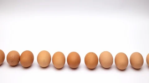 Eggs rolling on white background - Stop motion Stock Footage 108071482