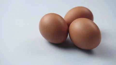 Eggs rotate on white background. Three fresh, organic and healthy chicken egg. Stockbeeldmateriaal 181170917