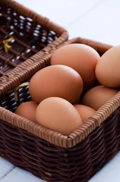Eggs in rustic basket Stock Photos