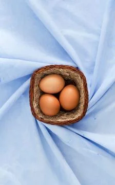 Eggs in rustic basket Stock Photos
