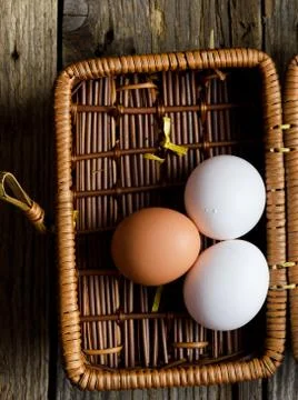 Eggs in a rustic basket Stock Photos