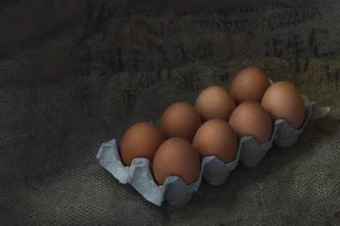 Eggs on sackcloth background Stock Photos