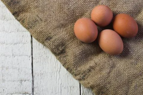 Eggs on sackcloth background Stock Photos