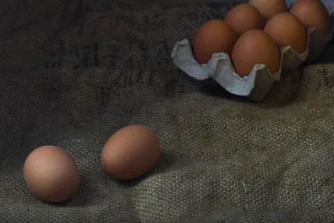 Eggs on sackcloth background Stock Photos