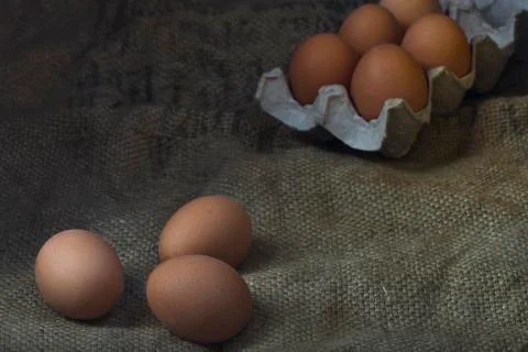 Eggs on sackcloth background Stock Photos