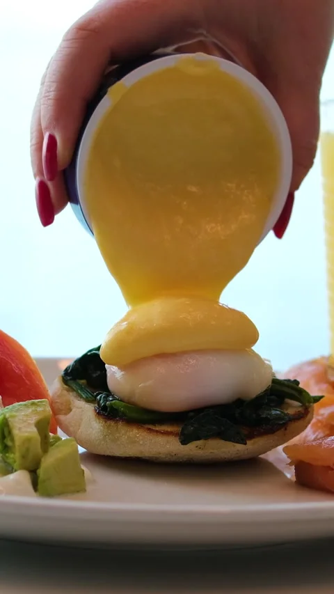 Eggs salmon juice Savoring eggs benedict topped with fresh salmon and creamy Stock Footage 317724969