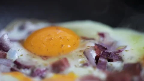 Eggs scramble with ham on hot pan Stock Footage 169899526