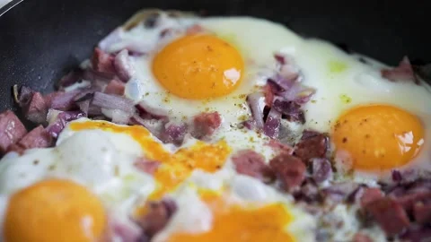 Eggs scramble with ham on hot pan Stock Footage 169899787