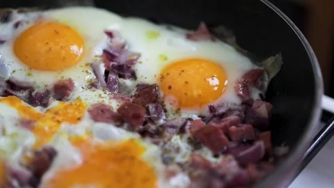 Eggs scramble with ham on hot pan Stock Footage 169899919