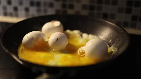 Eggs scrambling in pan with cracked shells on top Stock Footage 329449500