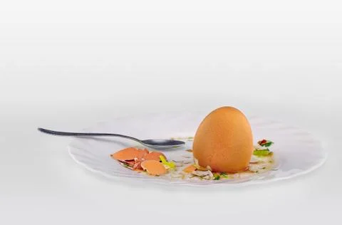 Egg's shells and teaspoon on a plate Stock Photos