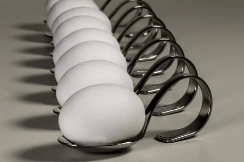 Eggs On Silver Spoons Stock Photos