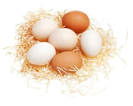 Eggs in straw nest. Stock Photos