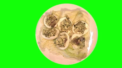 Eggs stuffed with champignons and spinach on cabbage leaves on plate, top shot Stock Footage 47584982