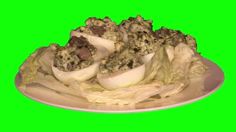 Eggs stuffed with champignons and spinach on cabbage leaves on plate Stock Footage 47585428