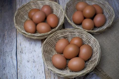Eggs in three wicker baskets Stock Photos