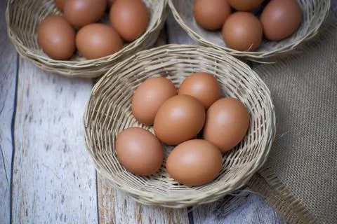 Eggs in three wicker baskets Stock Photos