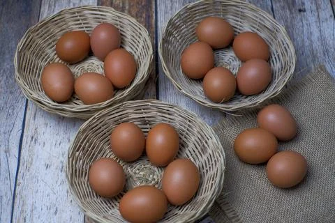 Eggs in three wicker baskets Stock Photos
