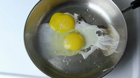 Eggs Thrown on Pan Stock Footage 45816914