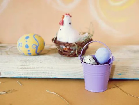 Eggs, toy chicken, Easter decor on a light wooden table Stock Photos