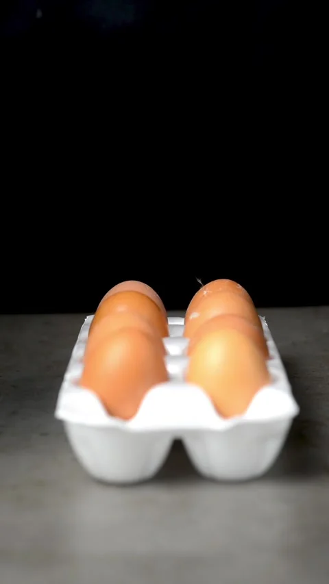 Eggs in a tray on a dark background Stock Footage 247199095