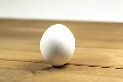 Eggs on a while plate sitting on the kitchen table waiting to be cracked Stock Photos