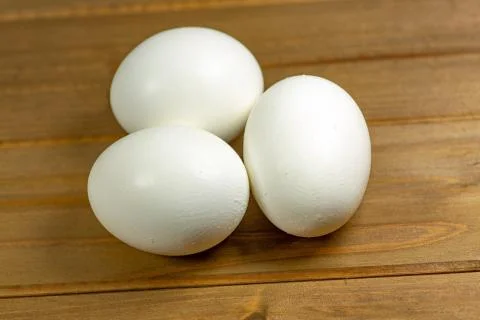 Eggs on a while plate sitting on the kitchen table waiting to be cracked Stock Photos