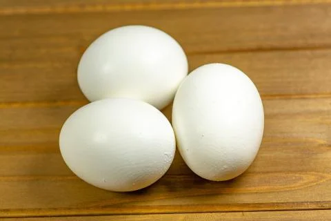 Eggs on a while plate sitting on the kitchen table waiting to be cracked Stock Photos