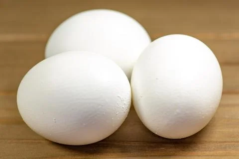 Eggs on a while plate sitting on the kitchen table waiting to be cracked Stock Photos