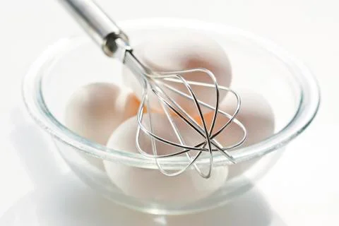 Eggs with whisk Stock Photos