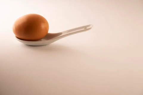 Eggs in a white spoon Stock Photos