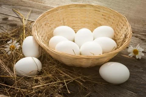 Eggs in a wicker basket Stock Photos