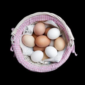 Eggs in wicker basket Stock Photos