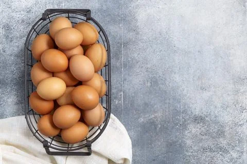 Eggs in wire basket with copy space above Stock-Fotos