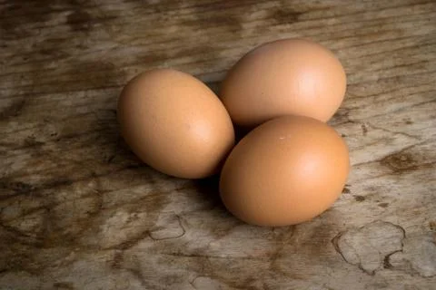 Eggs on wood background Stock Photos