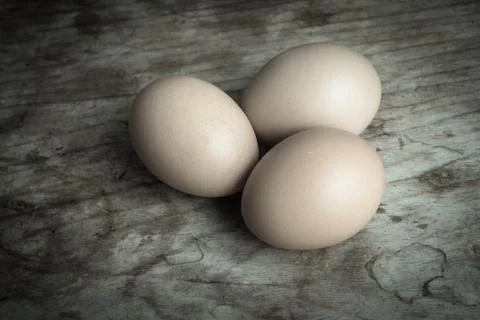 Eggs on wood background Stock Photos
