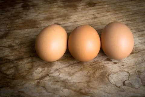 Eggs on wood background Foto stock