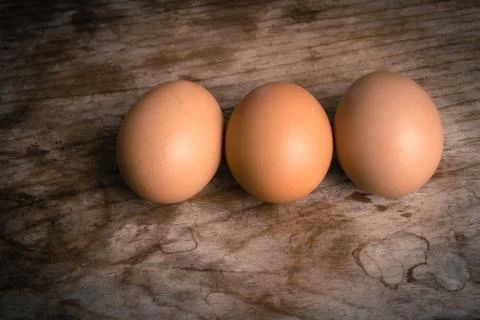 Eggs on wood background Foto stock