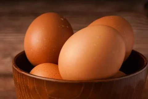 Eggs on a wooden background Stock Photos