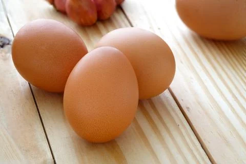 Eggs on wooden table with selective focus Photos