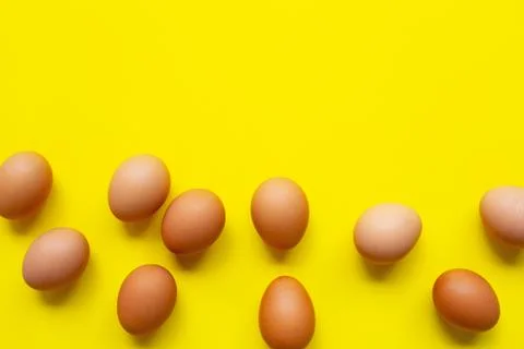 Eggs on yellow background. Stock Photos