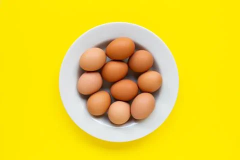 Eggs on yellow background. Stock Photos