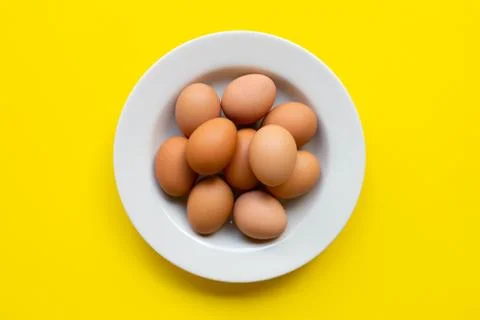 Eggs on yellow background. Foto stock