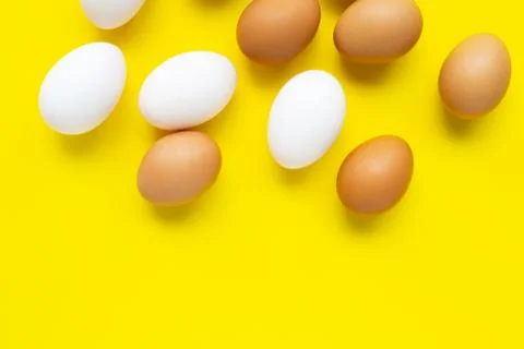 Eggs on yellow background. Stock Photos