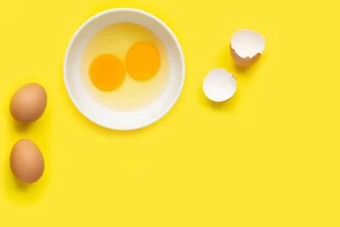 Eggs on yellow background. Stock Photos