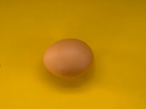 Eggs on a yellow background Stock Photos